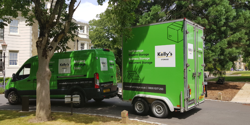 picture of a Kelly's green storage van carrying a mobile storage unit