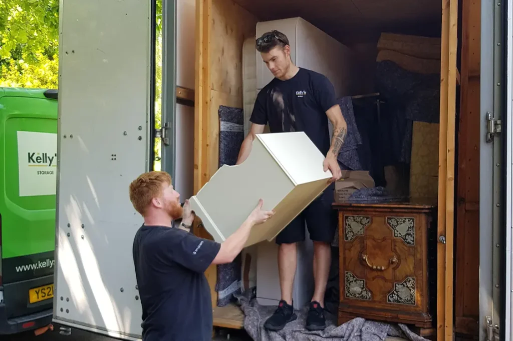 Two Kelly's staff carefully unloading a customers container.