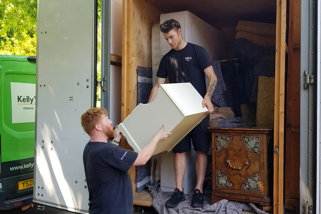 Two Kelly's staff carefully unloading a customers container.