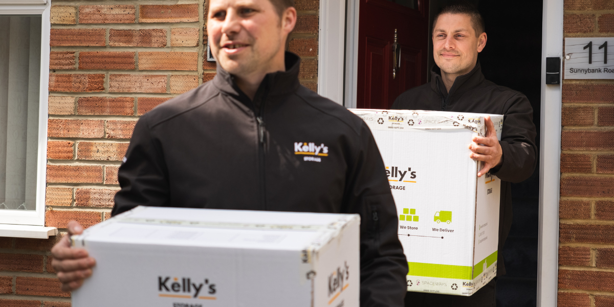 Picture of two self storage employees carrying storage boxes onto their van