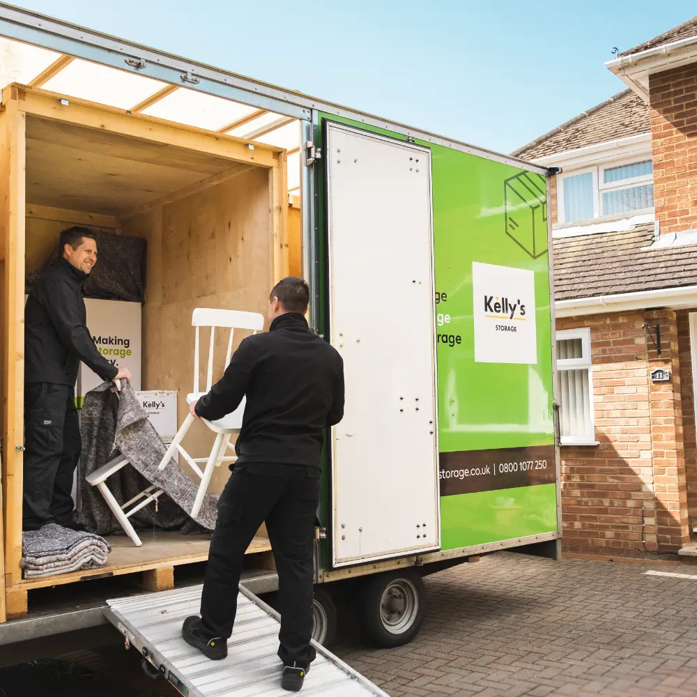 Image of two self storage professionals loading a customers goods into a storage unit in Guildford